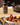 A bottle of Watkins Yellowstone Spice next to a plate of cooked sausage and potatoes
